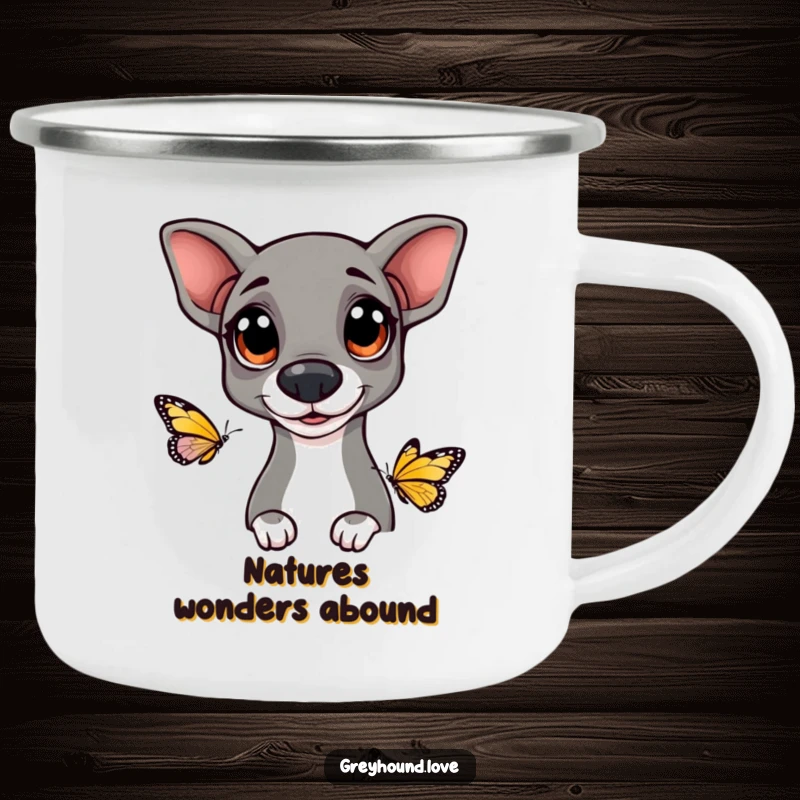 Funny Greyhound camping mug showing a dog with big, happy eyes curiously watching a butterfly, perfect for outdoor enjoyment.