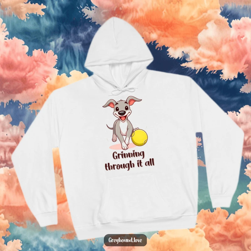Funny greyhound hoodie featuring a dog with a comical grin chasing a tennis ball, offering warmth and playful canine energy.