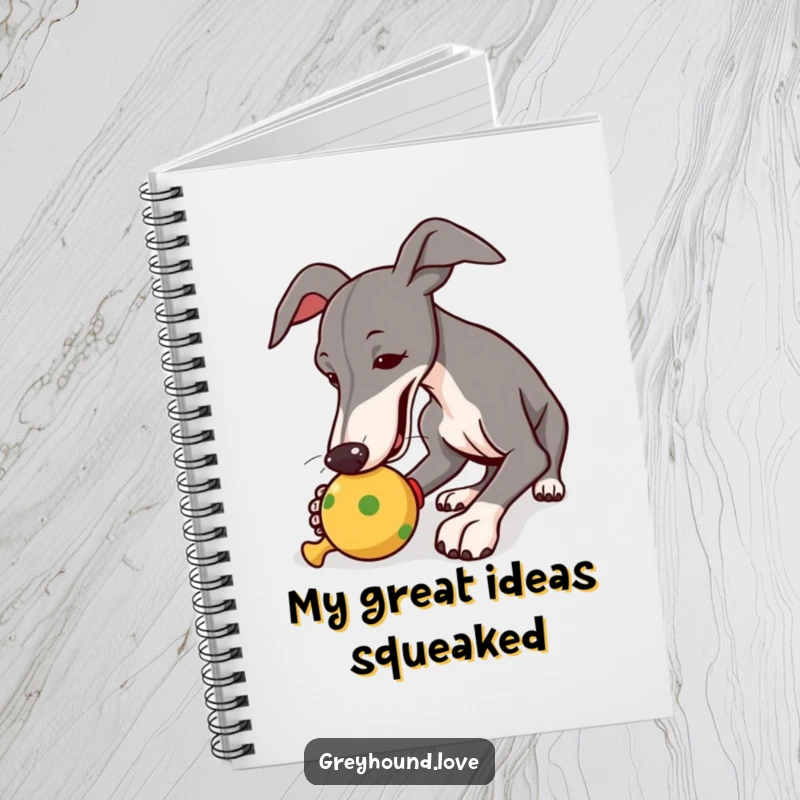 Funny notebook cover with a greyhound intently nudging a squeaky toy, encouraging creative and playful note-taking.