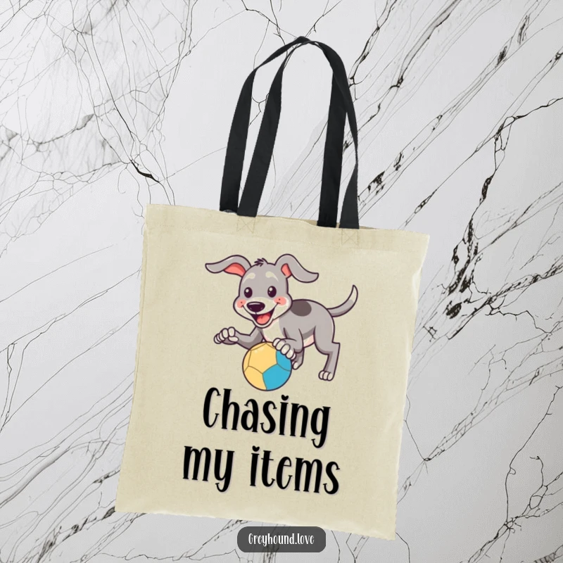 Funny Tote Bag: A smiling greyhound's paws are reaching out to catch a bouncing ball, showcasing funny determination.
