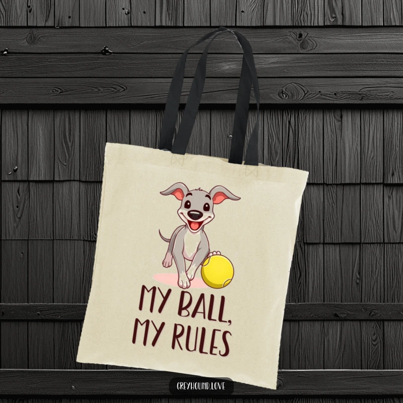 Funny greyhound tote bag with a comical grin, chasing a tennis ball, perfect for carrying items with playful canine flair.